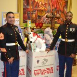 U.S. Marines Gunnery Sergeant Nicholas Lopez and Staff Sergeant Anthony Carrington dutifully guard the stash of Christmas presents collected Saturday night for Toys for Tots.